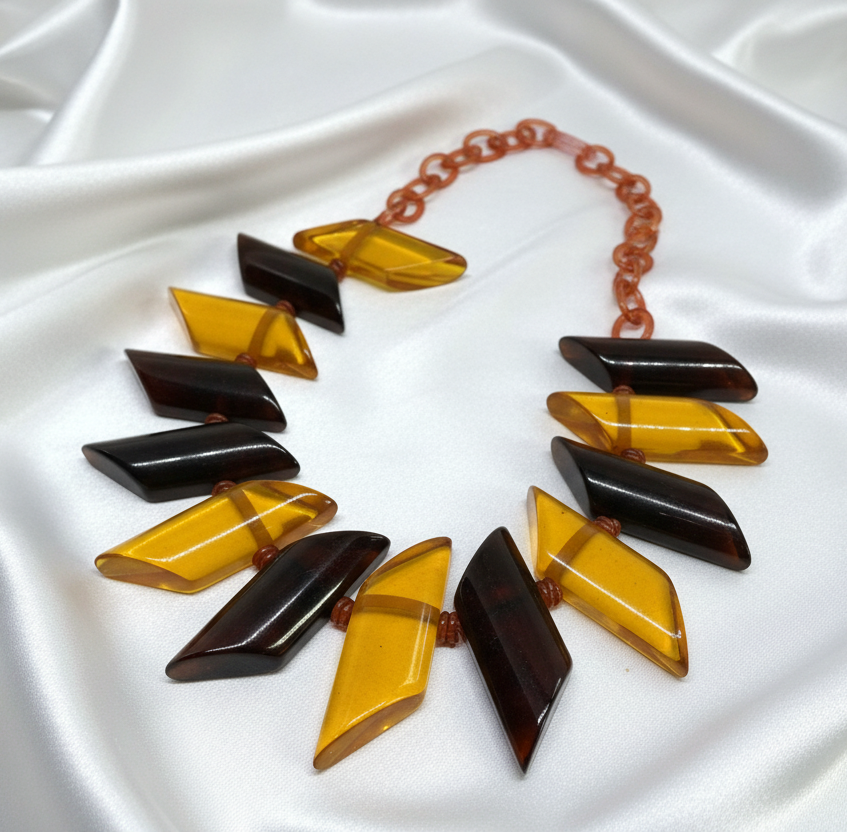 1930s Apple Juice Bakelite necklace on white satin