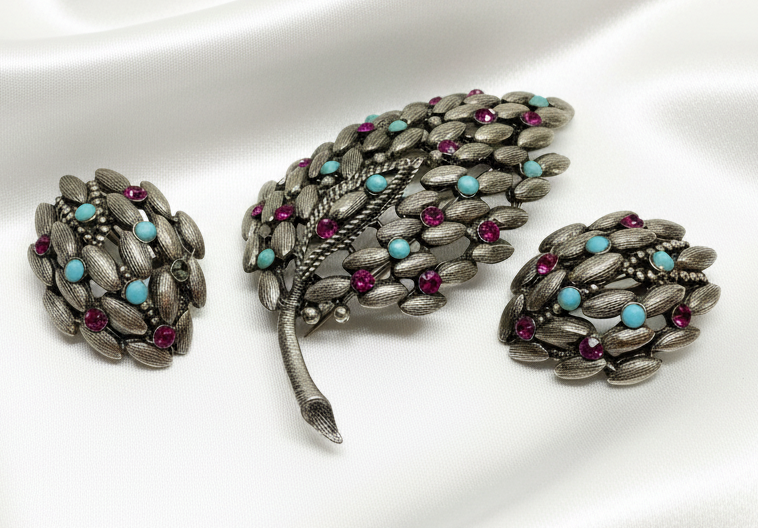 BSK brooch set on white satin background