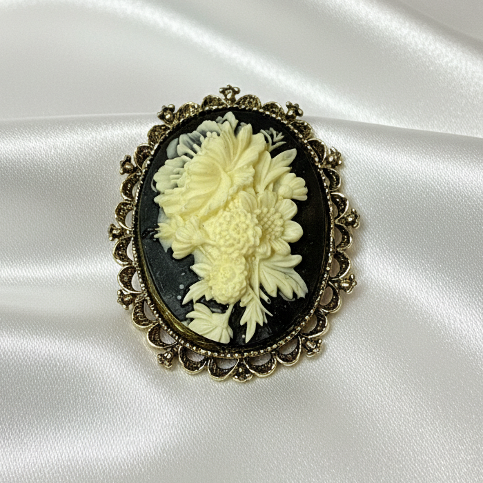 Gerry's brooch on white satin background