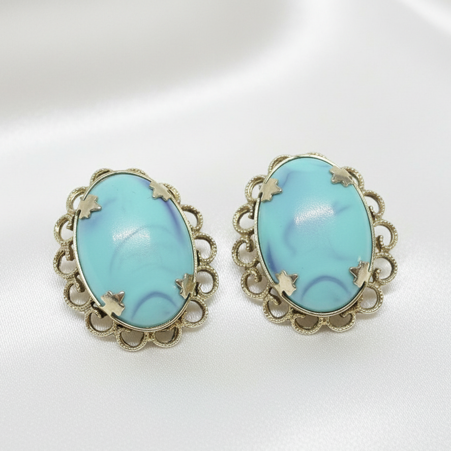 Turquoise earrings on silky white background