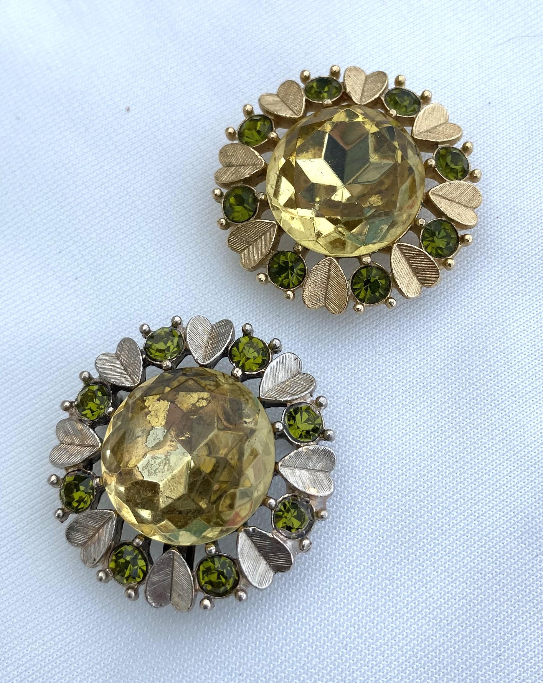 Avon brooches - one silver and one gold