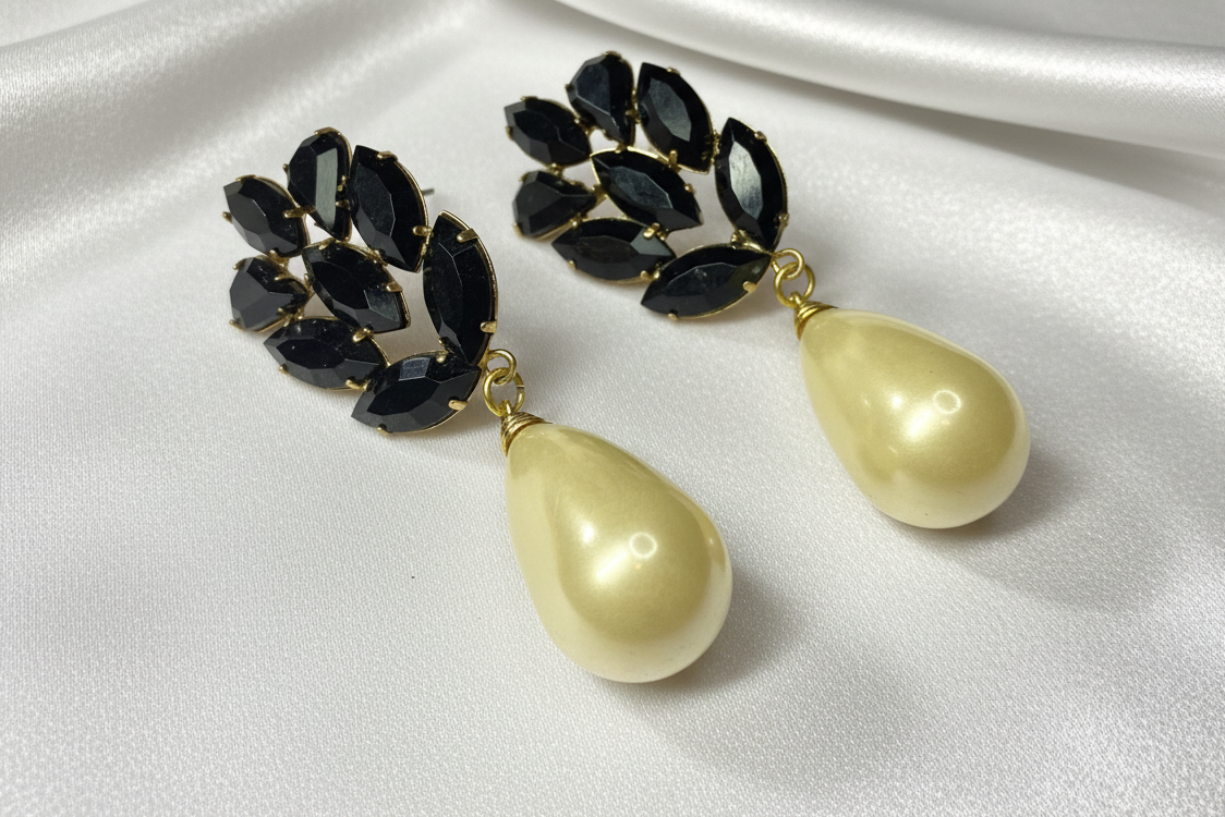 Vintage earrings on white satin background